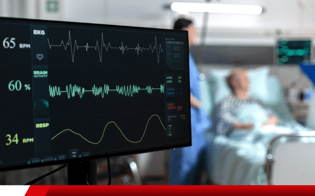Monitor multiparamétrico exibindo sinais vitais de paciente hospitalar.